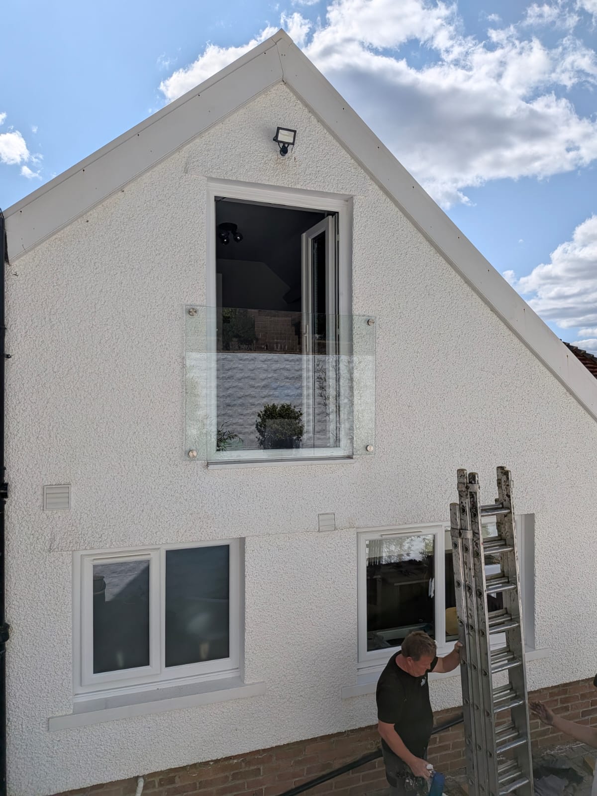 White uPVC windows with Juliet balcony by Essential Glazing Products