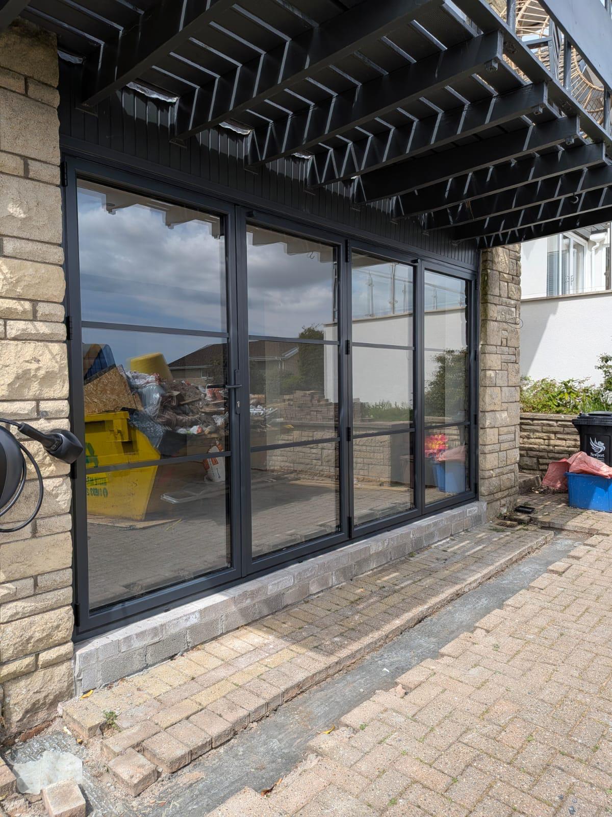 Aluminium Bi-folds installation by Essential Glazing Products
