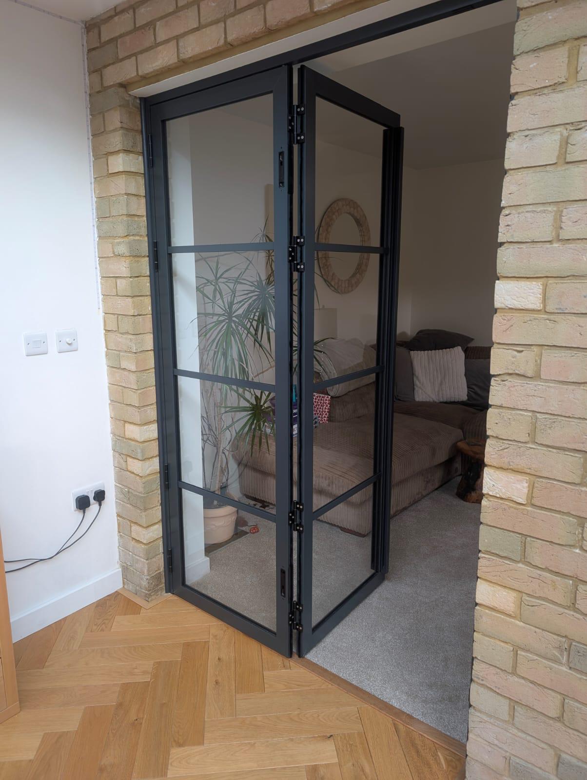 Aluminium Bi-folds installation by Essential Glazing Products