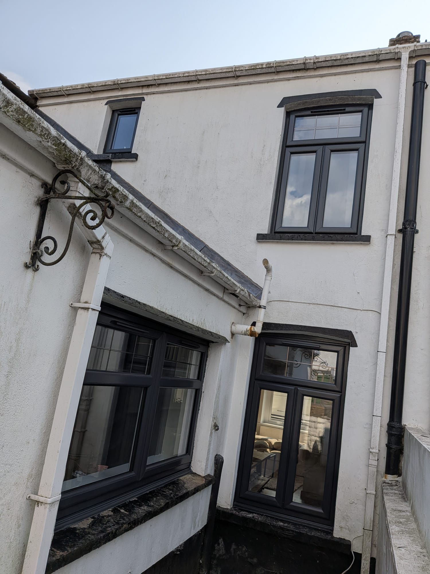 Anthracite grey uPVC windows to the rear of a house by Essential Glazing Products
