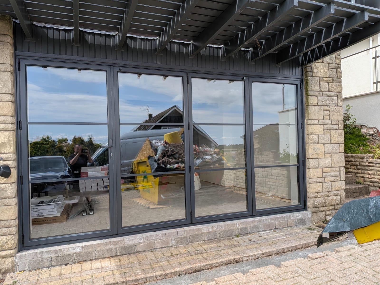 Aluminium Bi-folds installation by Essential Glazing Products