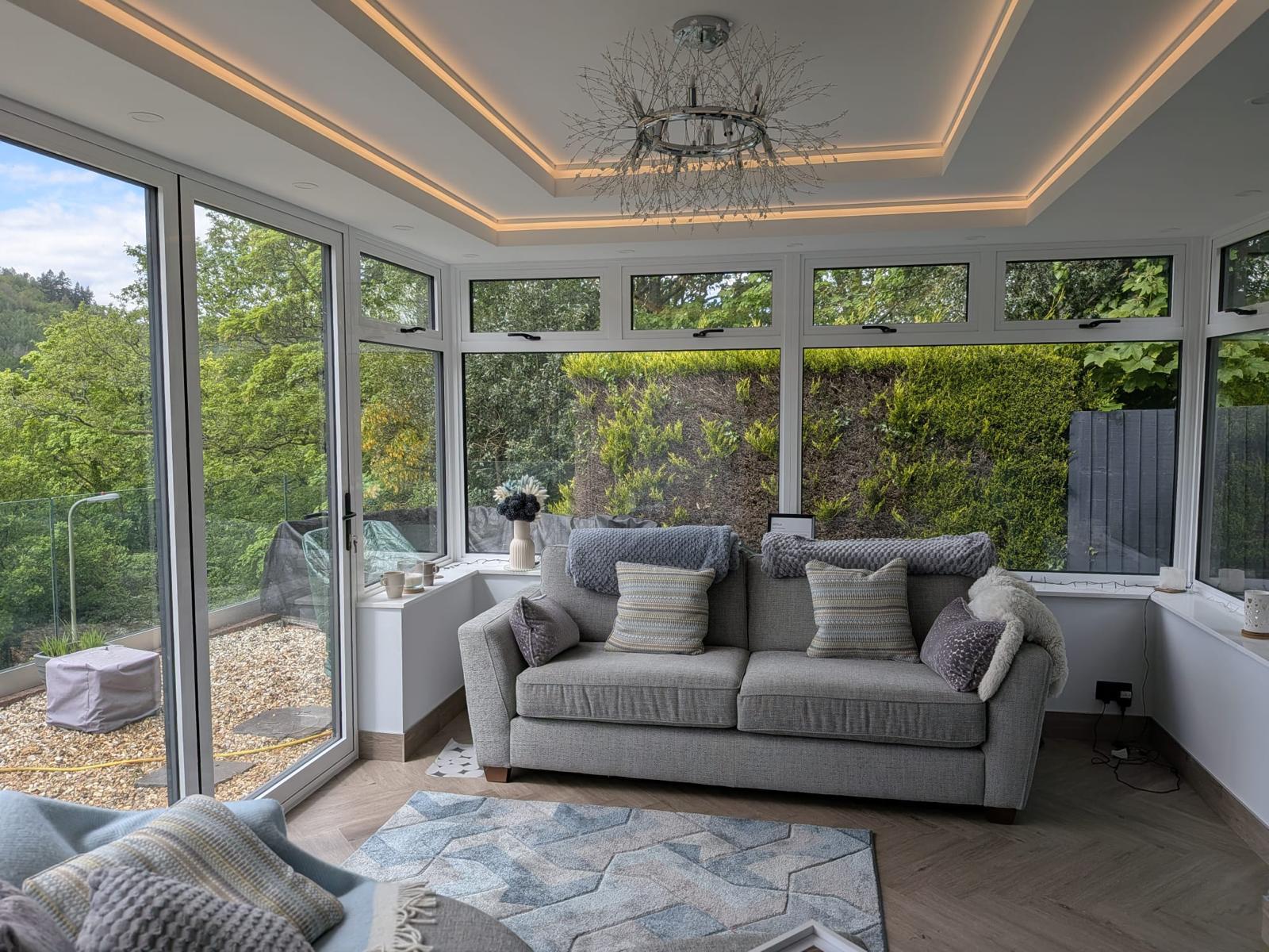 Interior of a fitted conservatory looking out over a Welsh garden