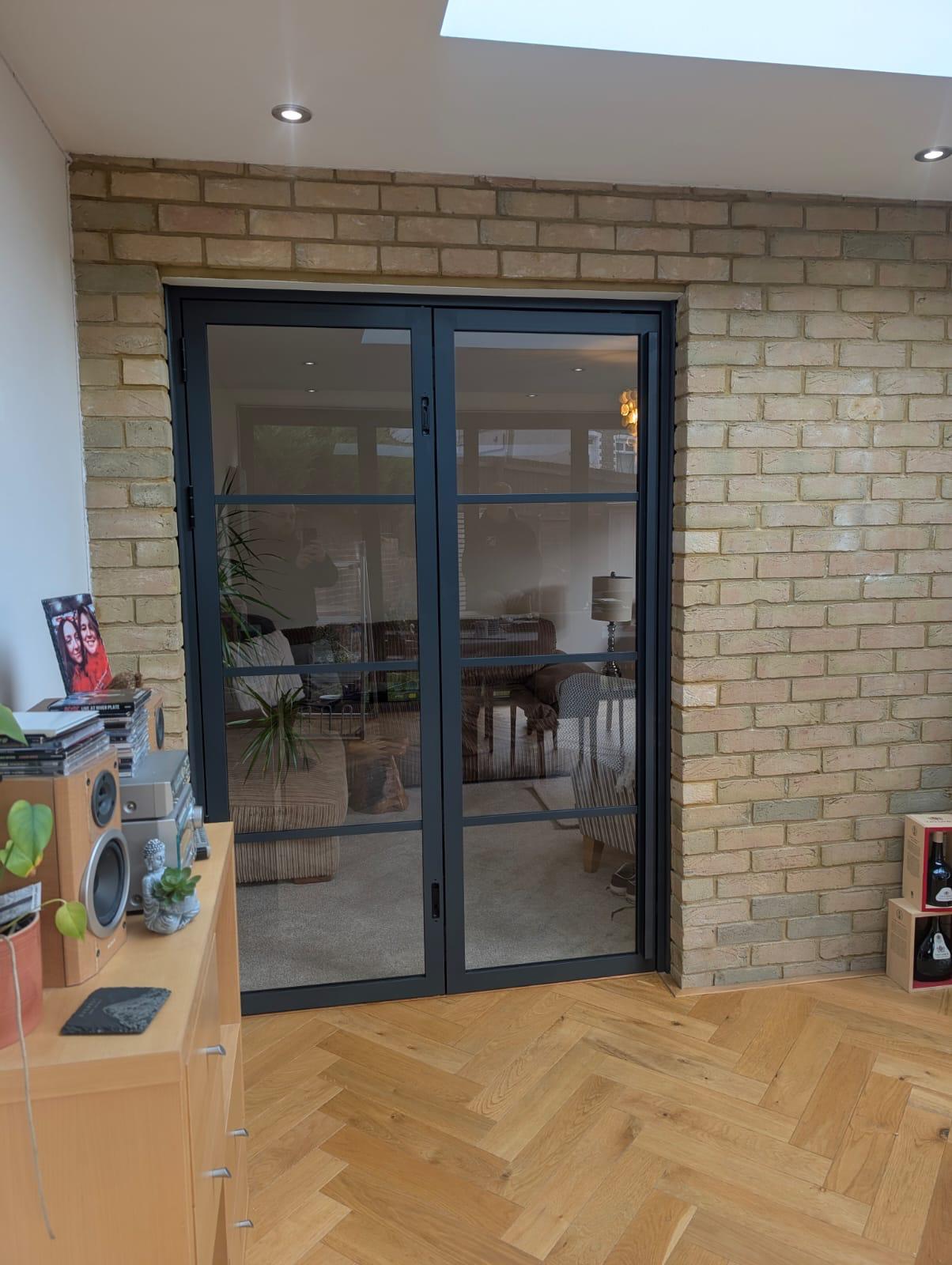 Aluminium Bi-folds installation by Essential Glazing Products